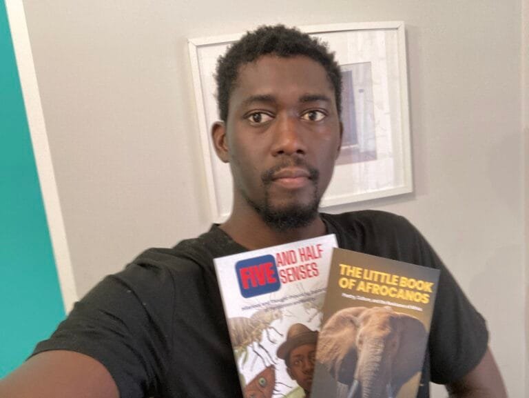 lamin ceesay Gambian Writer on his newletter-letter from lamin ceesay, with his books on his hand. in black shirt with white background on a blog post, the essence of african literature and the gambian literature