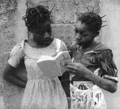 two african girls reading a book