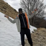 lamin ceesay gambian writer in the moutains with visible snow near him