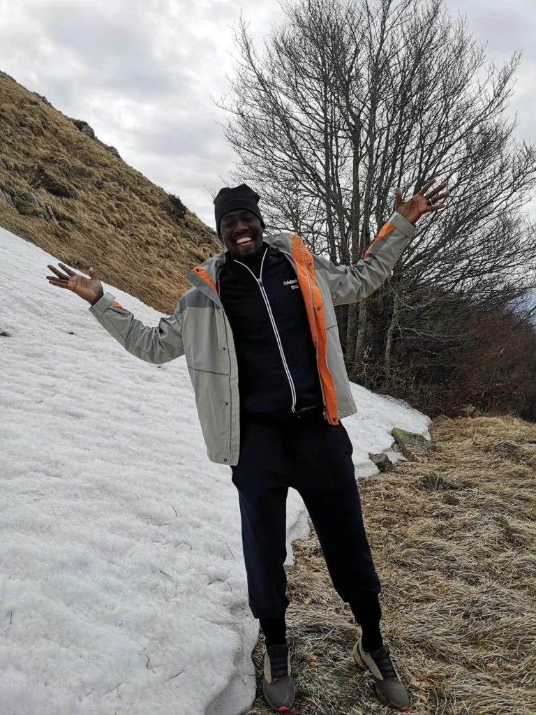 lamin ceesay gambian writer in the moutains with visible snow near him
