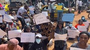 Demonstrators holding signs during an anti-corruption rally in The Gambia