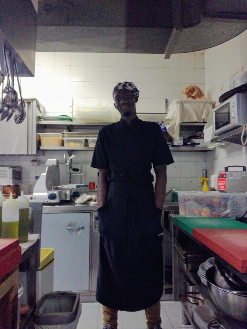 In chef's blacks in a restaurant kitchen